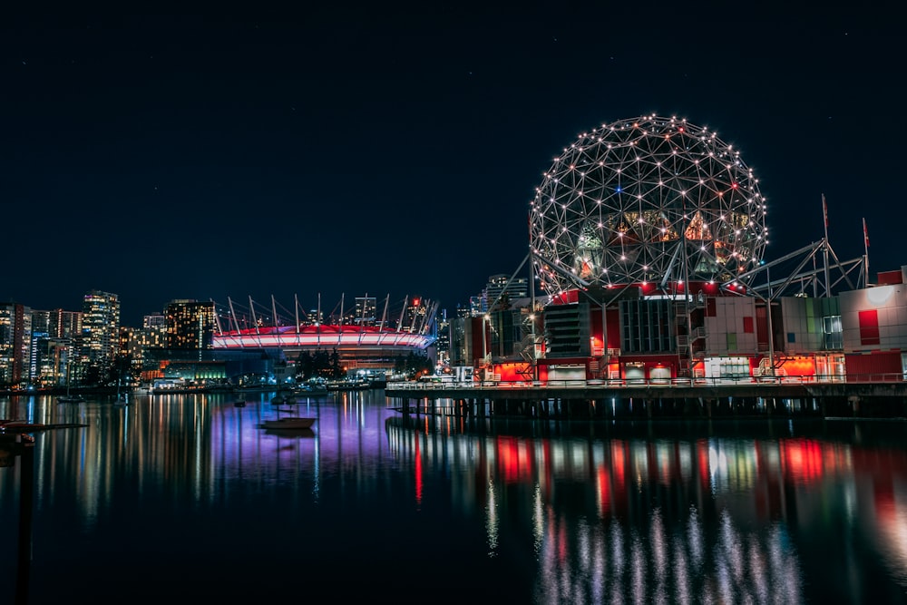 skyline photography of boat passing on waters overlooking buildings