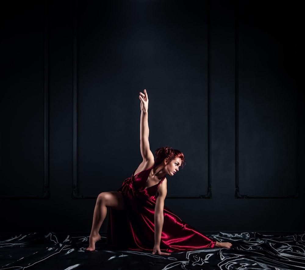 woman in red halter dress doing pose inside room