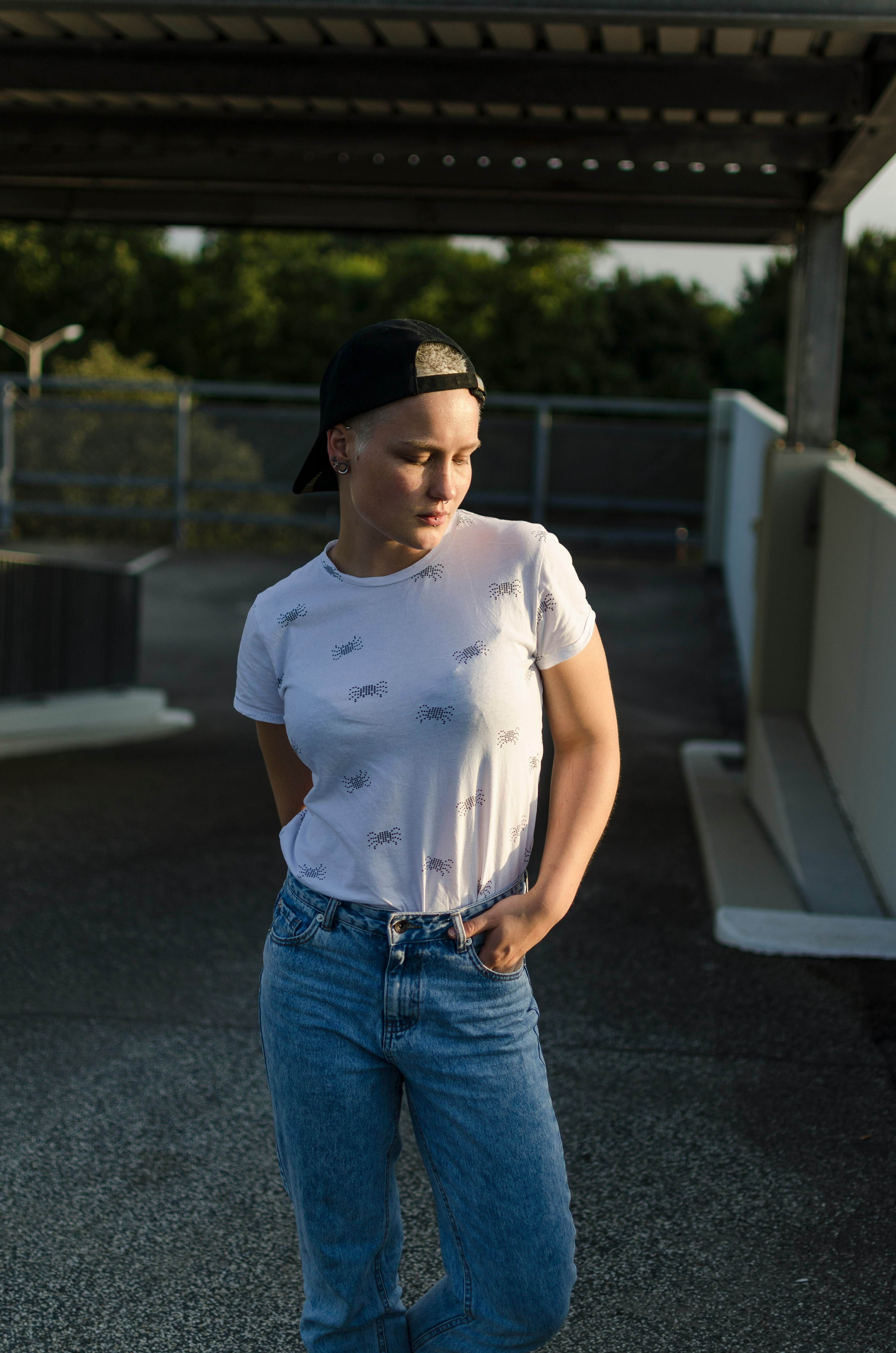 woman in white shirt standing near white rail