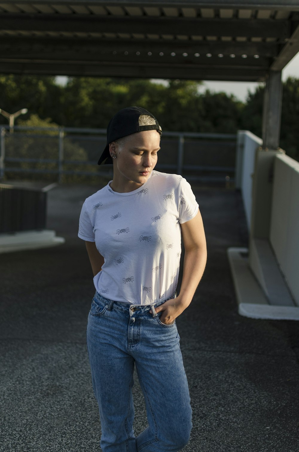 woman in white shirt standing near white rail