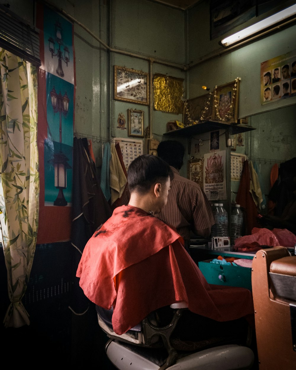 man with red hairdressing cape