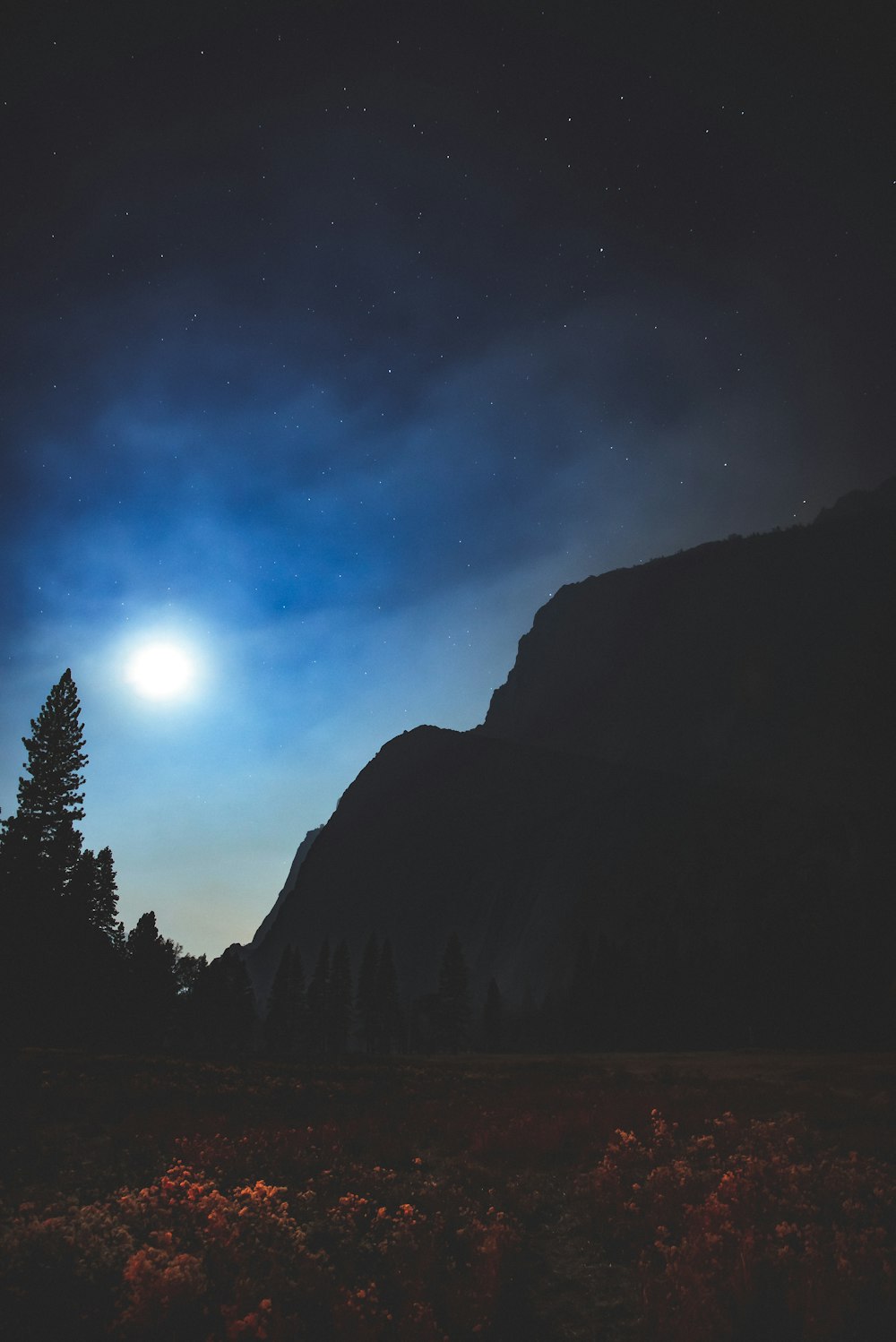 moon over mountain in silhouette