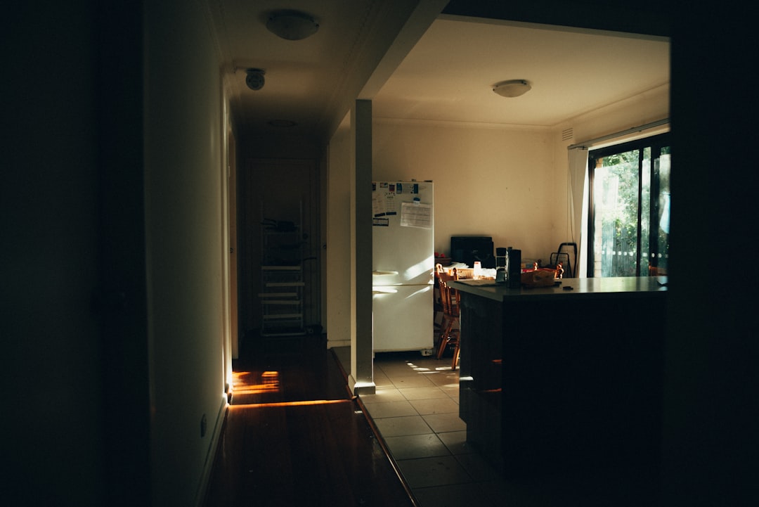 white bottom-mount refrigerator near window inside house