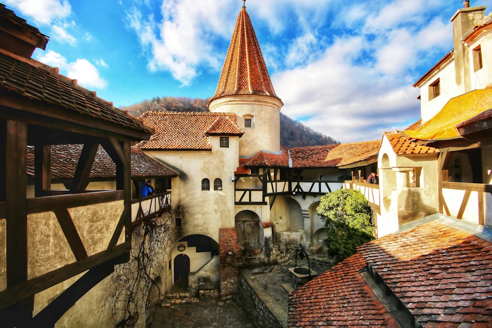 Aerial view of Bran Castle perched above forested hills in Transylvania, Romania