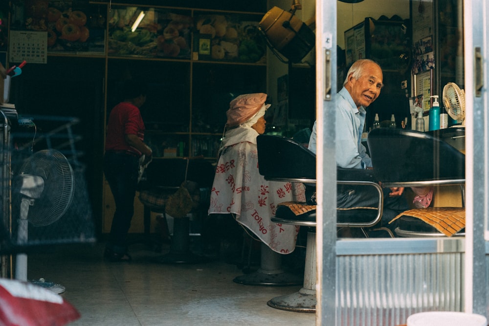 man sitting on barber chair