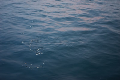 Ripples on a deep blue lake surface under a clear morning sky.