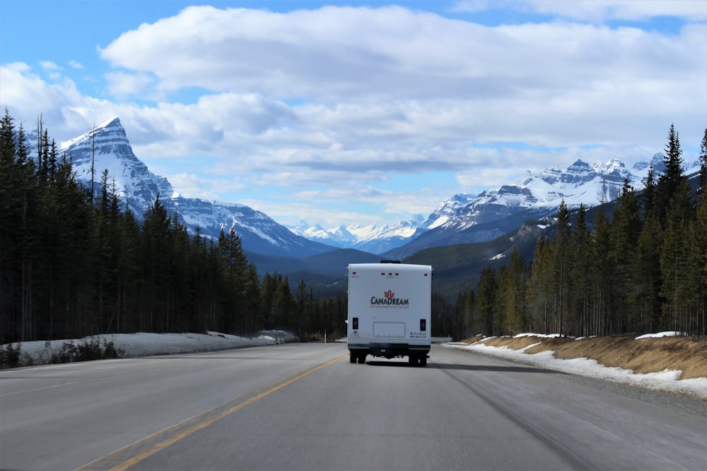 white box truck running on road