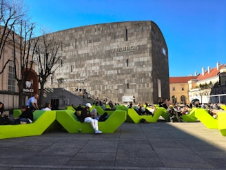 Contemporary public plaza featuring minimalist benches and greenery.