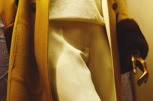 Beige women's trousers displayed on a mannequin highlighting the tailored fit and soft fabric.