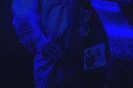 Iconic shot of Jaco holding his famous fretless bass, radiating his unique charisma