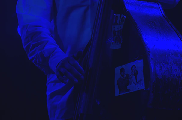 A candid shot of Jeff tuning his double bass before a live performance.