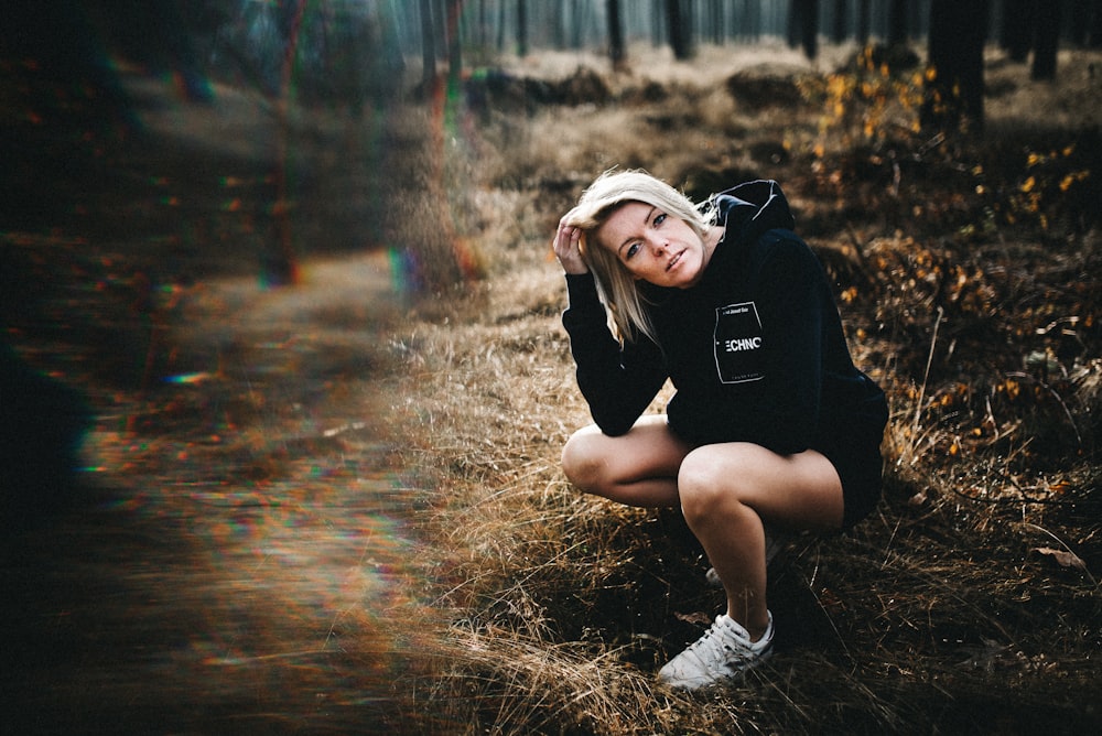 woman kneeling on green grass