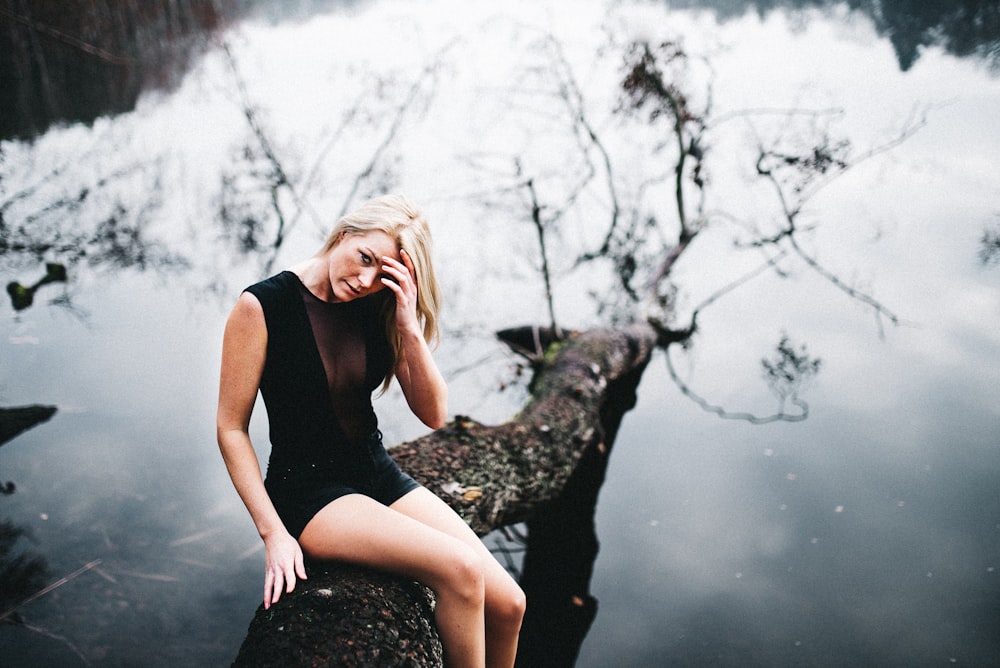 woman sitting on tree branch