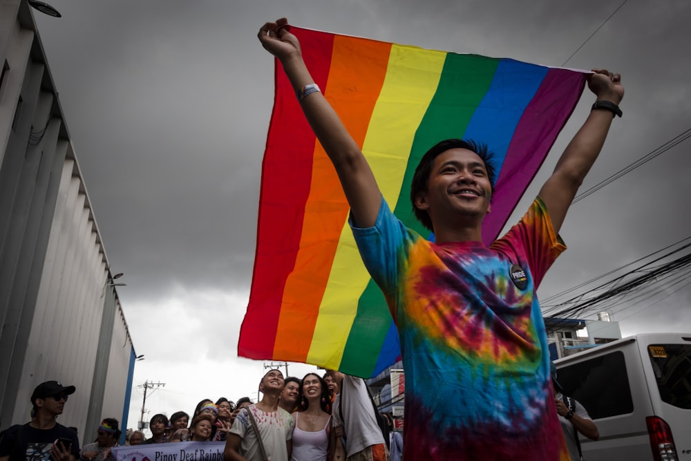 man holding LGBT flag