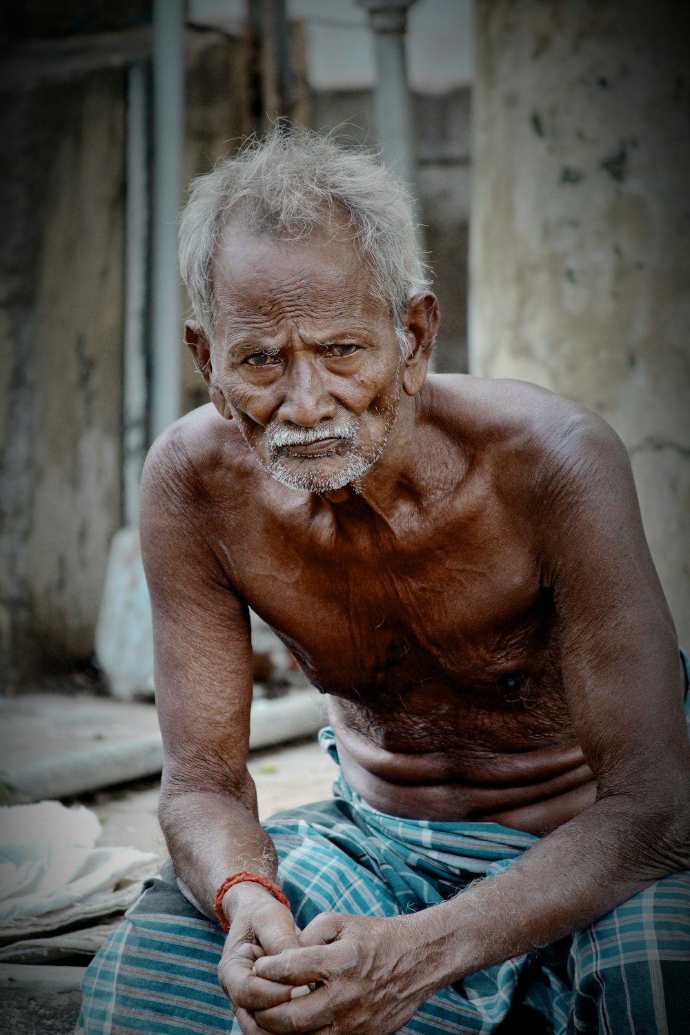 man sitting wearing sarong