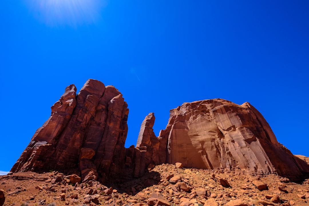 brown land formation under blue sky