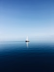 white sailboat at middle of ocean