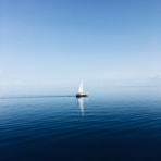 white sailboat at middle of ocean