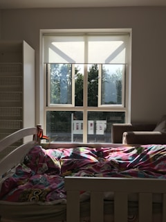 Sunlight streaming through windows onto a cozy room filled with books and toys