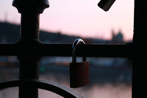 A locksmith replacing a commercial door lock on a sleek office entrance at dusk.
