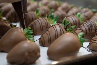 Elegant gift box filled with beautifully arranged chocolate-covered strawberries, ready to be offered.