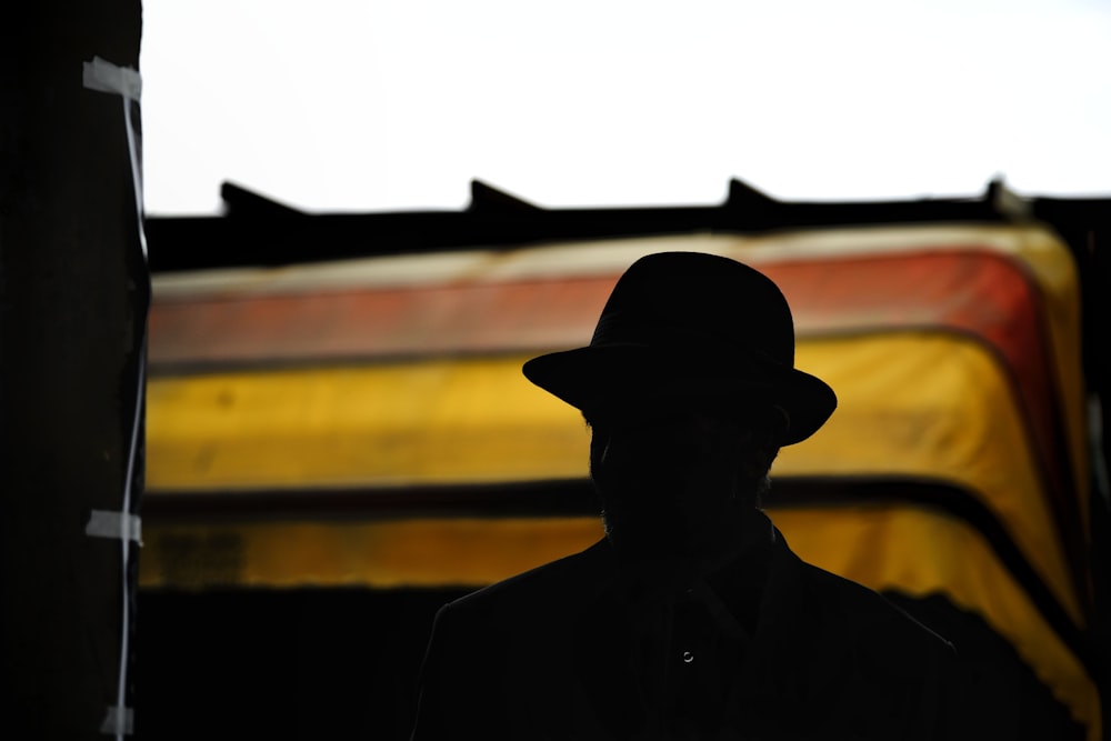 silhouette of person wearing hat photography