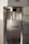 A close-up view of a Sodastream machine with a transparent bottle filled with carbonated water inside the machine. The Sodastream logo is visible on the bottle, and the machine has a white and metallic design.