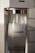 A close-up view of a Sodastream machine with a transparent bottle filled with carbonated water inside the machine. The Sodastream logo is visible on the bottle, and the machine has a white and metallic design.