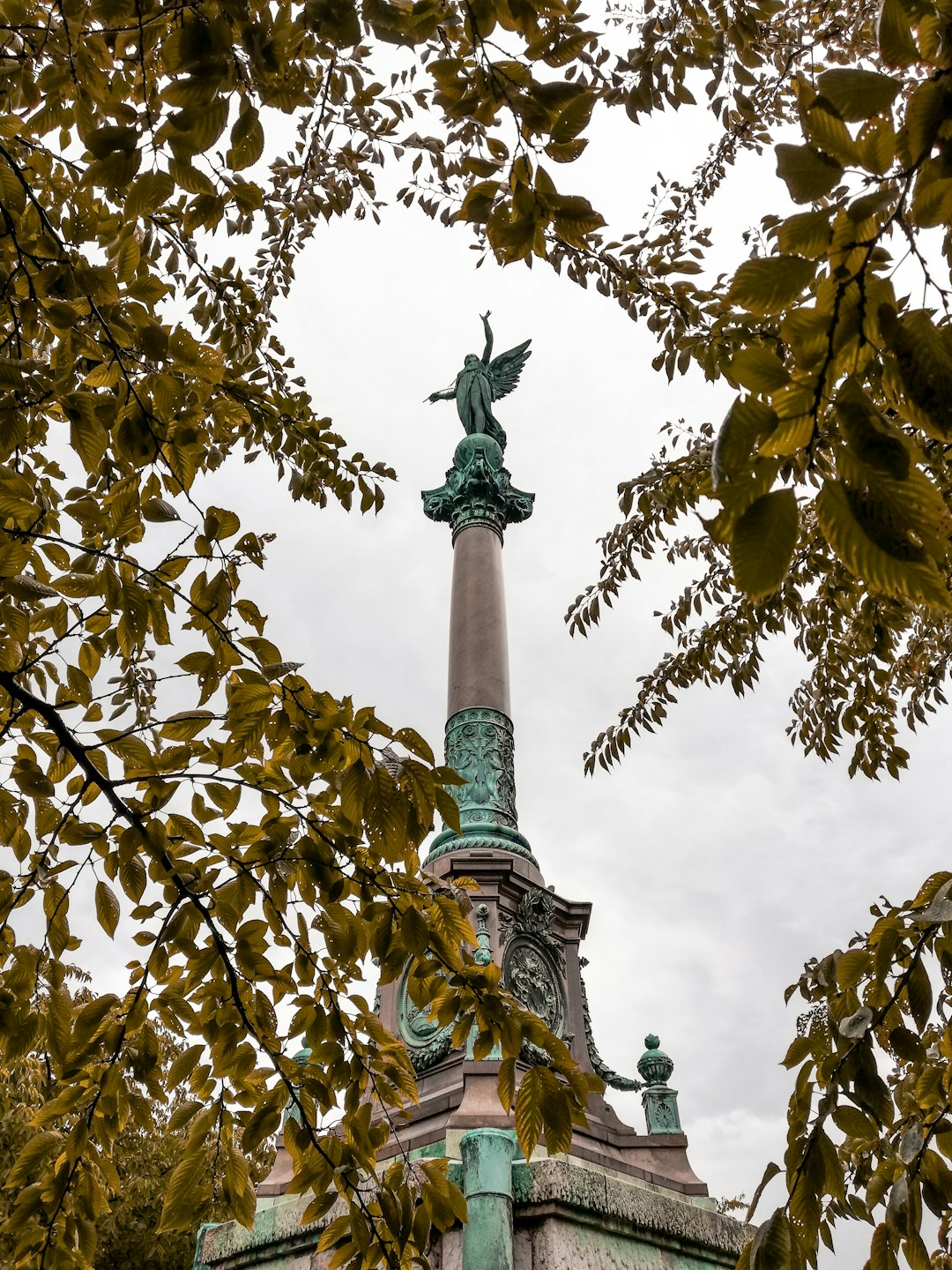 low angle photography of statue of angel