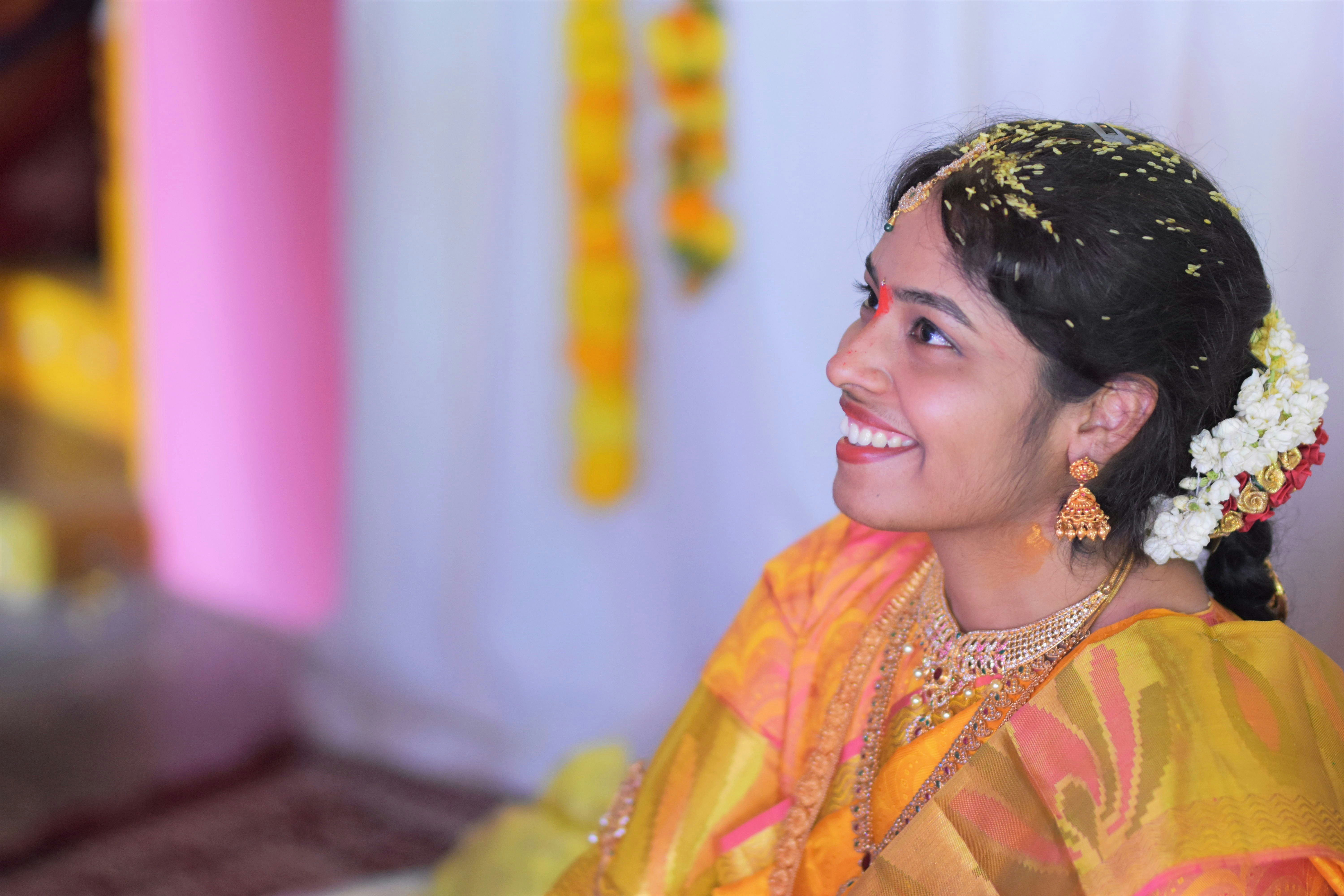 Young Indian woman smiling in traditional wear, warm light