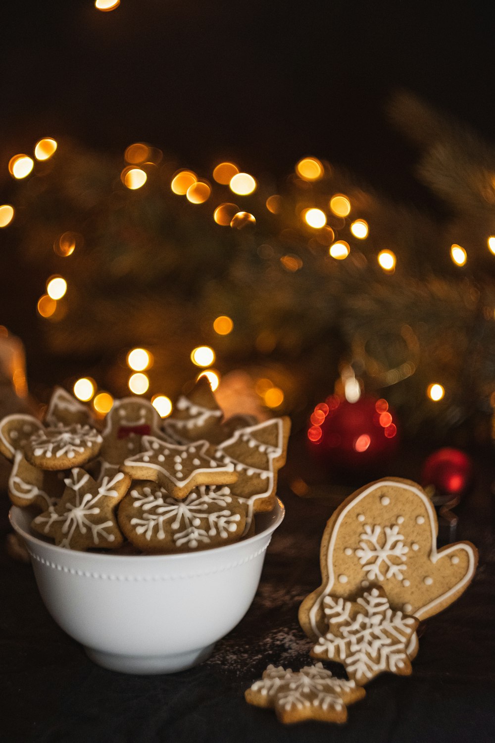cookies in bowl near Christmas tree