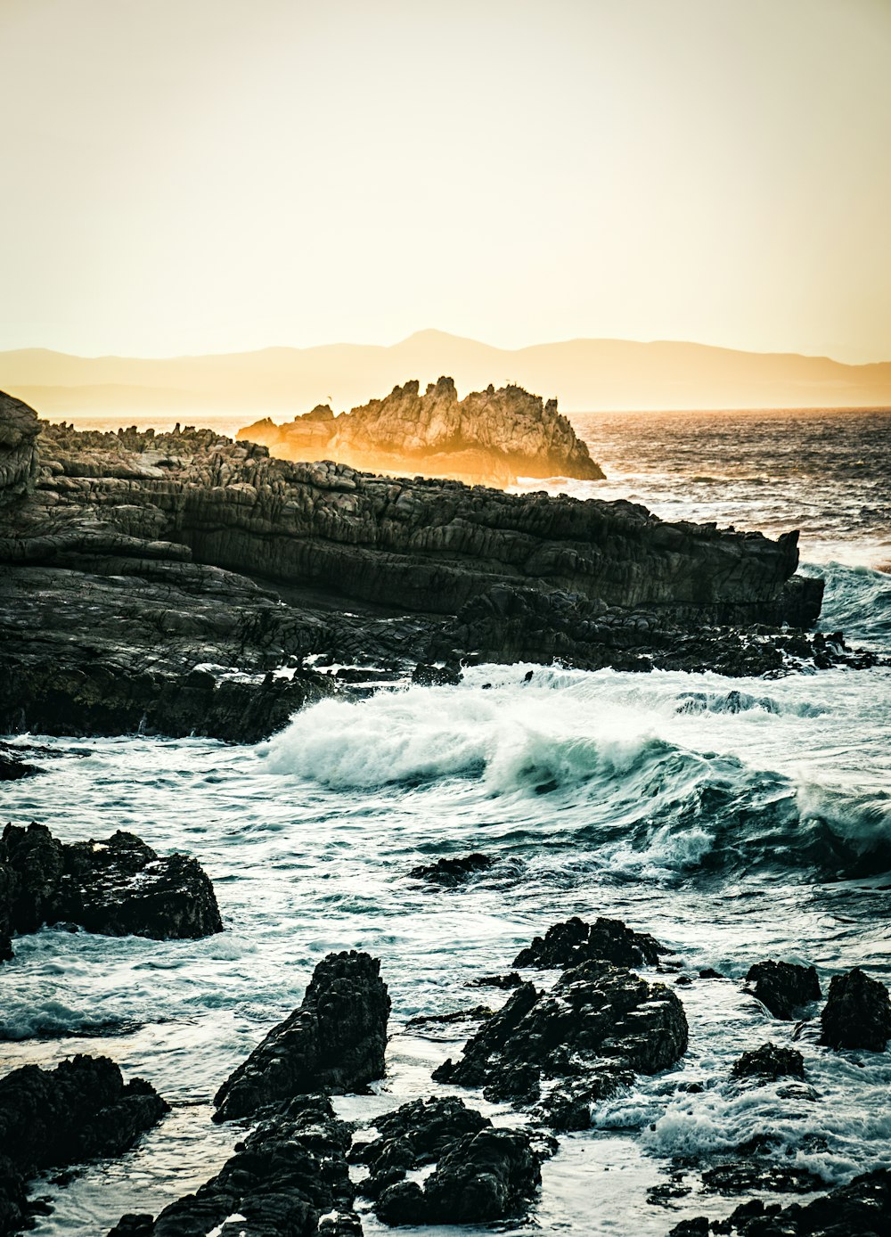 rock formation surrounded by sea