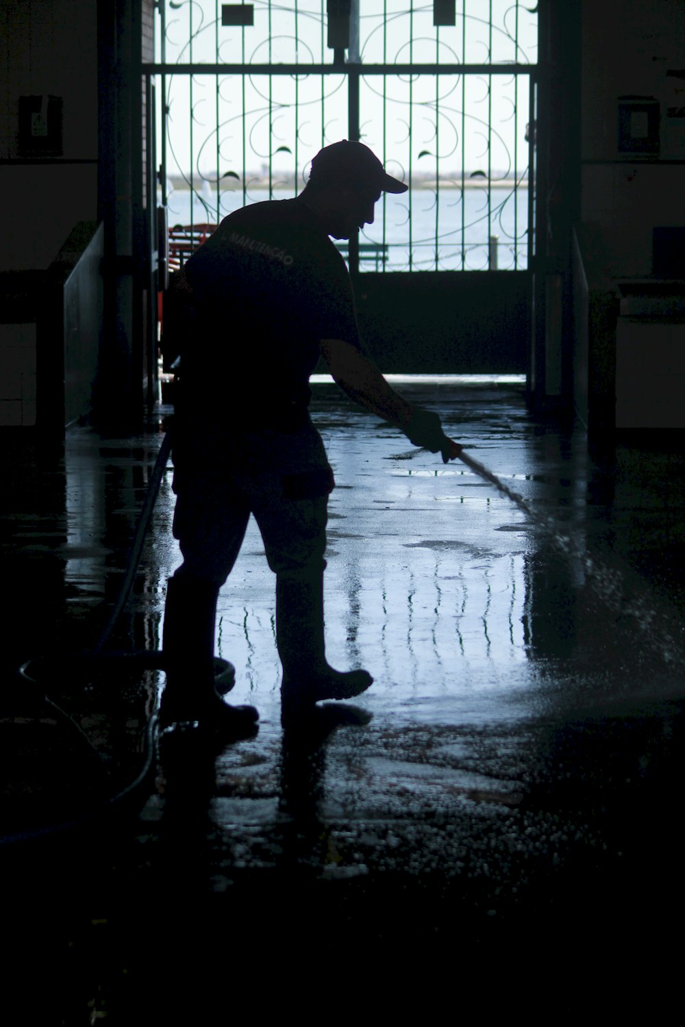 man pouring water from house inside building