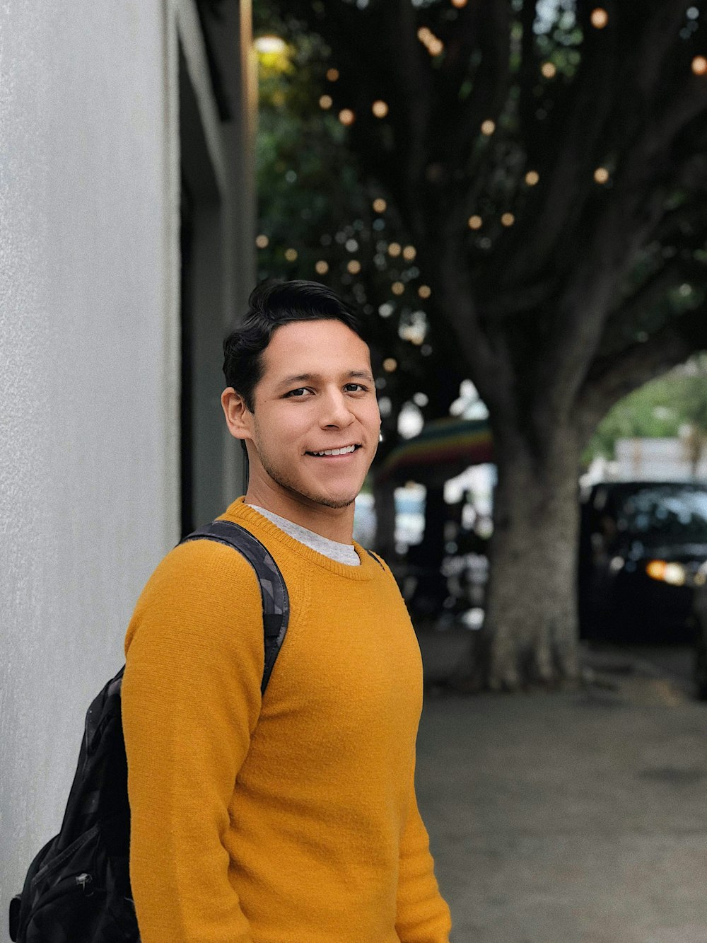 man wearing orange crew-neck sweater