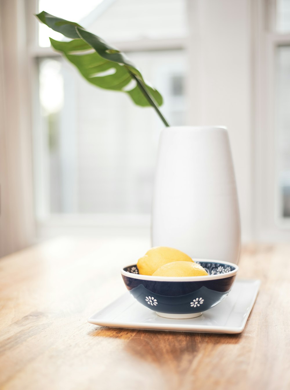 round black bowl beside vase on table