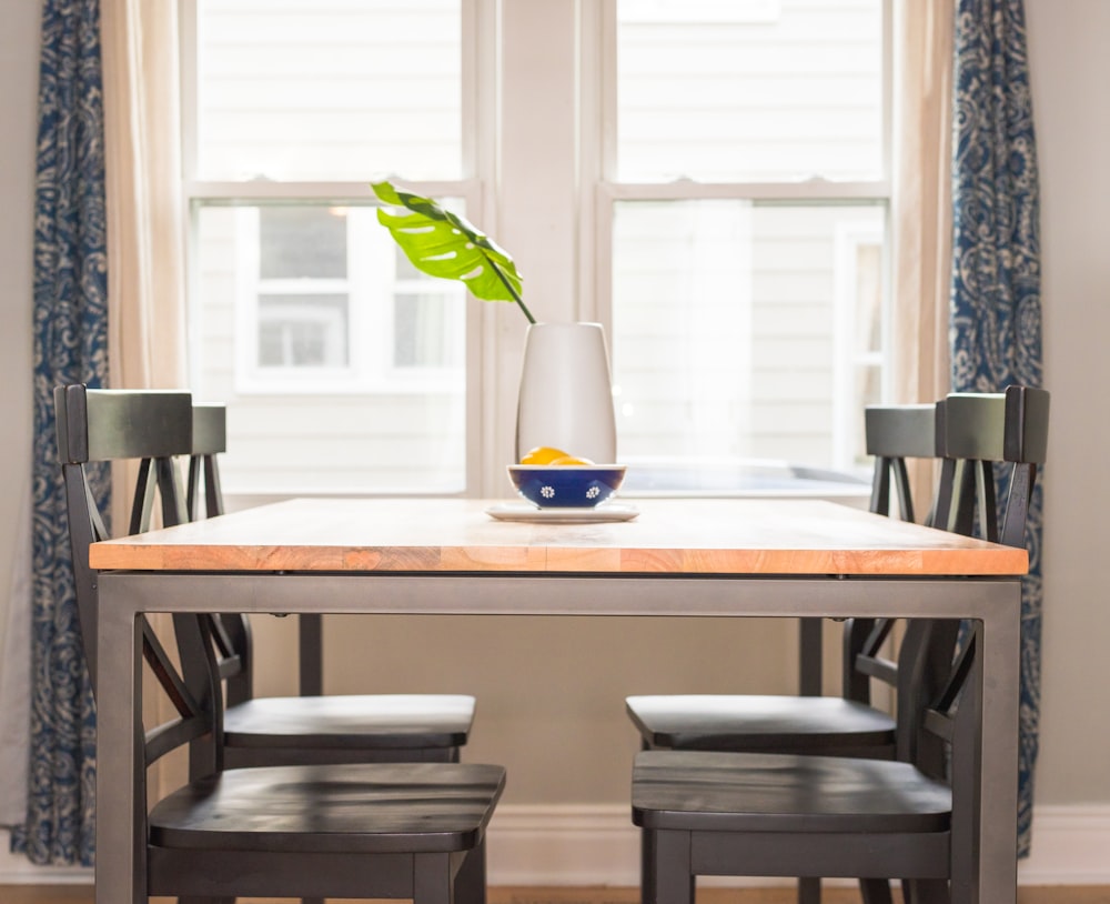 brown dining table and four chairs