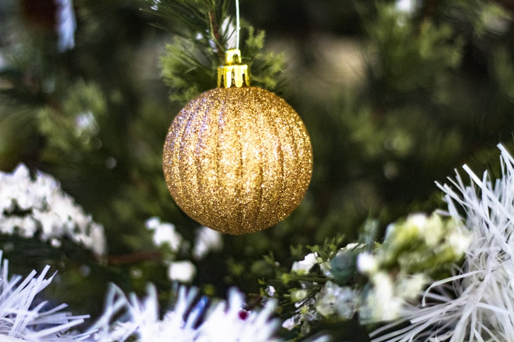 selective focus photography of gold Christmas bauble
