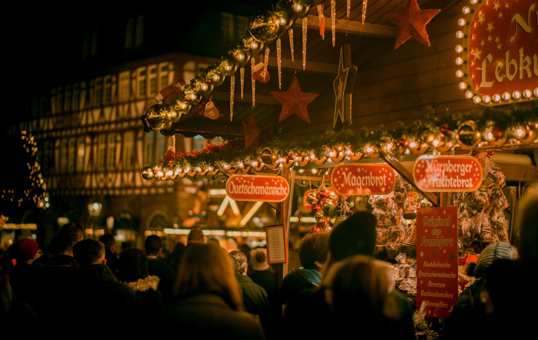 group of people near the store photography, A beautiful gingerbread booth at the Frankfurt City Christmas Market in Germ