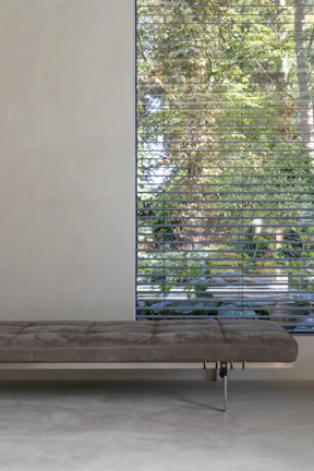 Elegant solid-wood bench in a softly lit modern interior with neutral palette.