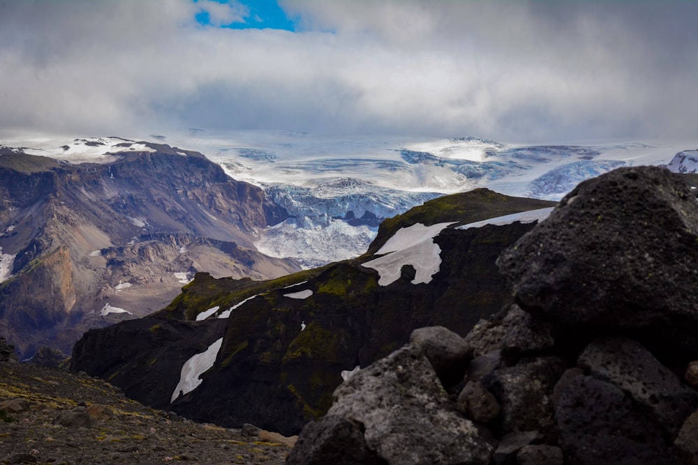 mountain range under dramatic clouds during daytime