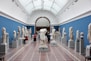 people watching statue in gallery room