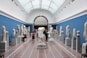 people watching statue in gallery room
