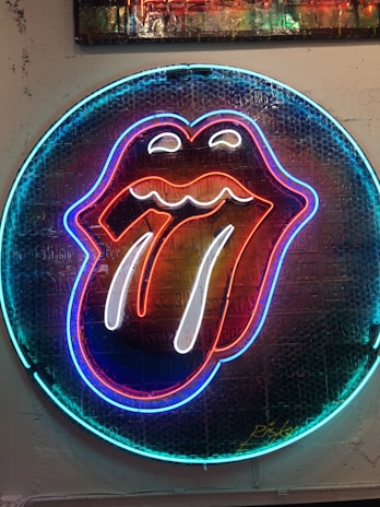 A sleek, modern dental icon glowing softly on a dark background.