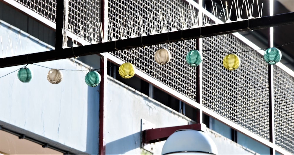 assorted-color Chinese lanterns near building during daytime