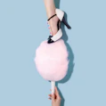 woman in blakc and white T-strap heeled sandal stepping on pink cotton candy