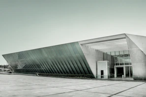 A sleek commercial building featuring glass facades and open spaces.