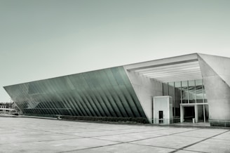 A sleek, newly constructed office building with large windows and a welcoming entrance.