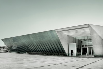 A sleek commercial building featuring glass facades and open spaces.