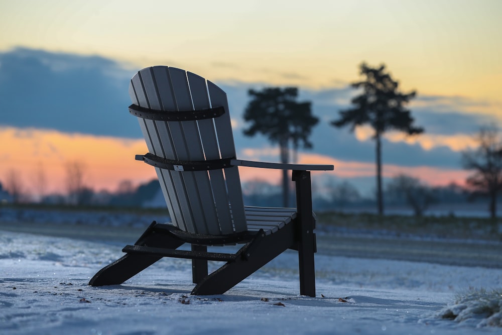 brown adirondack chair on shore