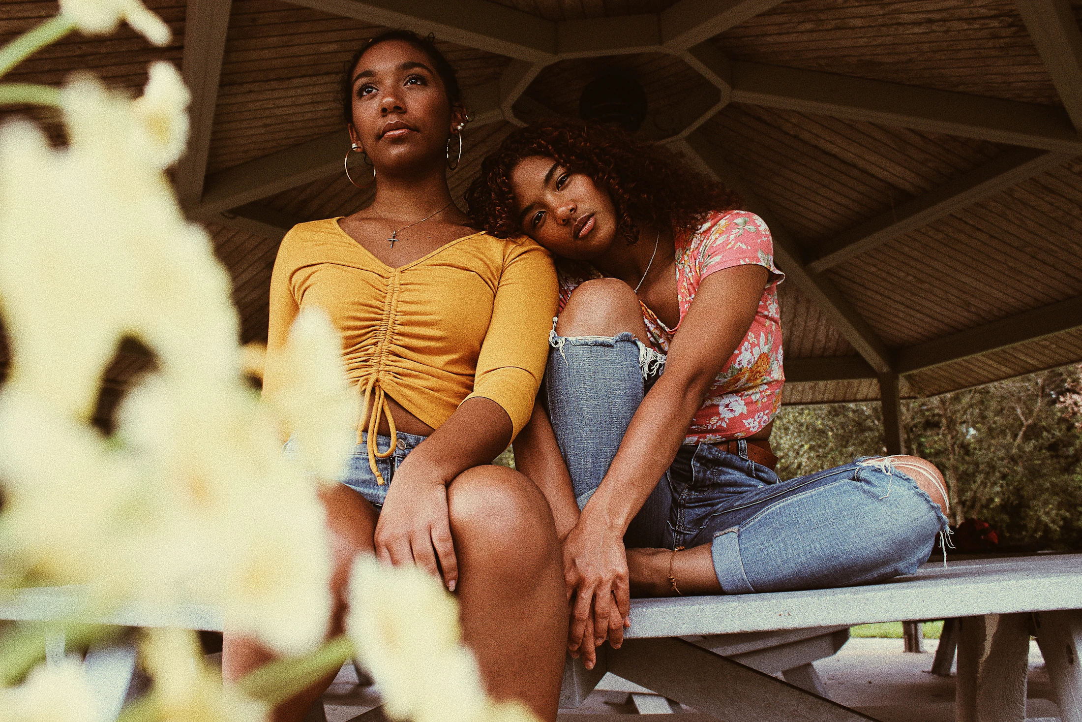 Three teenagers sitting together outdoors